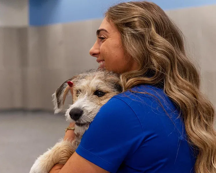 Worker holding dog